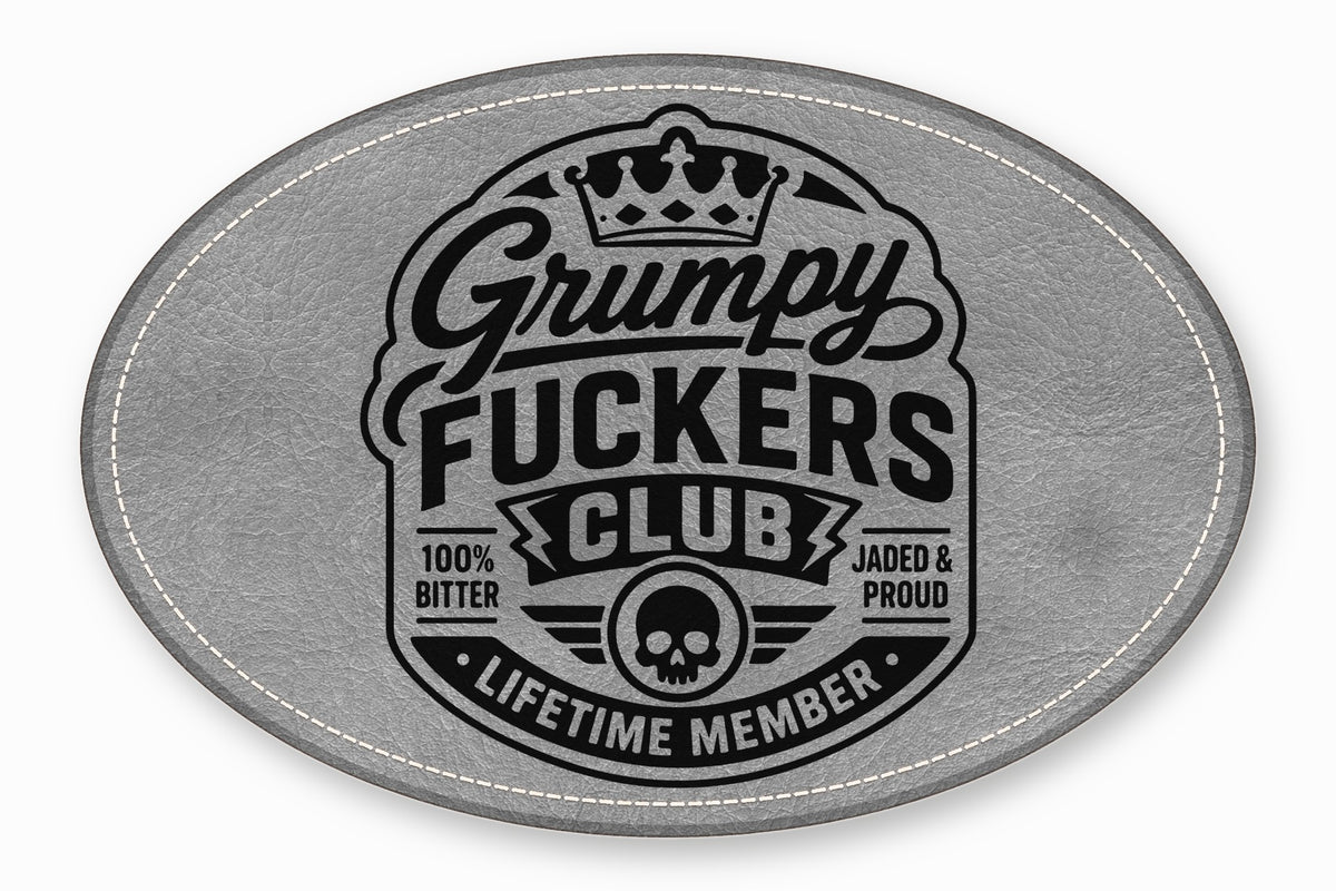 Oval gray faux leather patch with black embroidered text reading Grumpy Fuckers Club, crown, and skull.