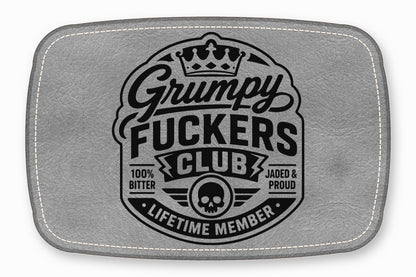 Grey leather patch with white stitched border featuring a black graphic and text reading Grumpy Fuckers Club.