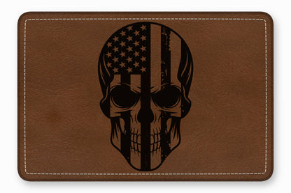 Brown leather patch with rounded corners, white perimeter stitching, and a black skull and American flag graphic.