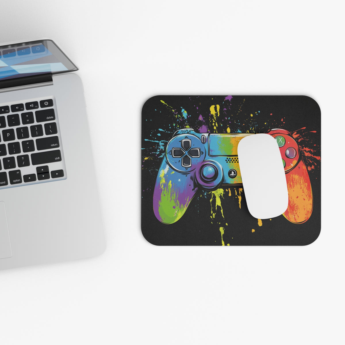 Colorful, abstract gaming controller design on a black mousepad with a white mouse.