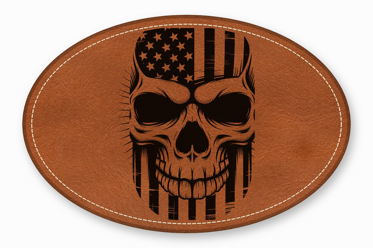 An oval brown leather patch with white perimeter stitching featuring a black skull and American flag graphic.
