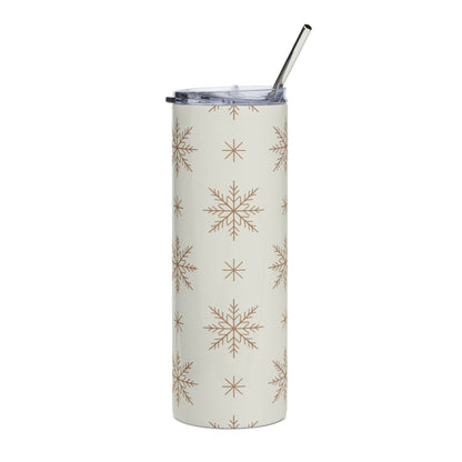 White tumbler with a tan snowflake pattern and a silver straw.
