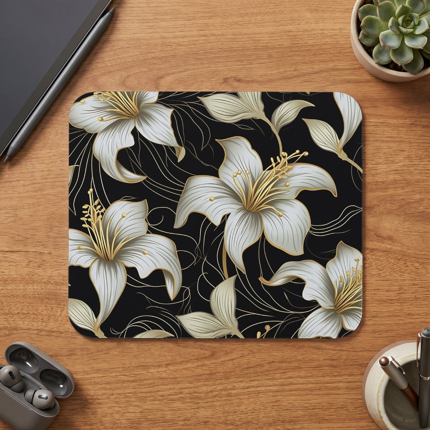 Mousepad with white and gold floral pattern on black background.