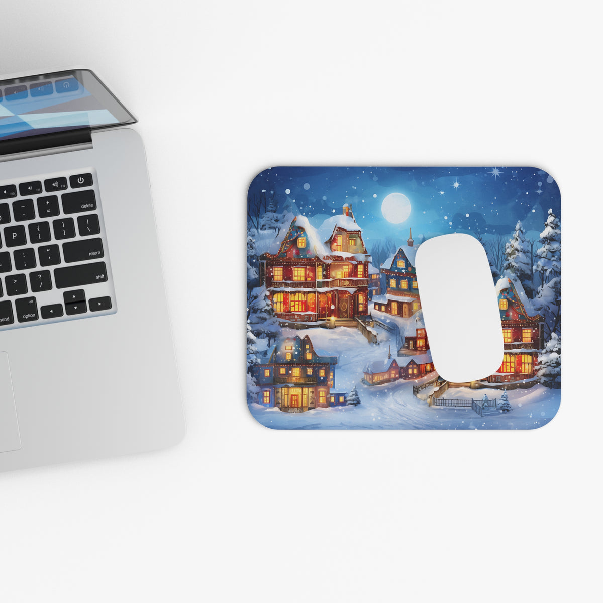Mousepad with a festive, snowy village scene illuminated by Christmas lights.