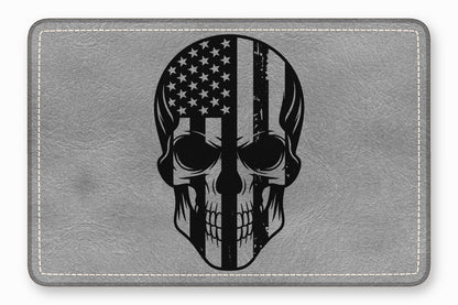 Rectangular gray leather patch featuring a black skull graphic with a distressed American flag pattern.