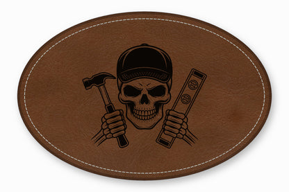 An oval brown leather patch with white stitching featuring a black skeleton worker holding a hammer and level.
