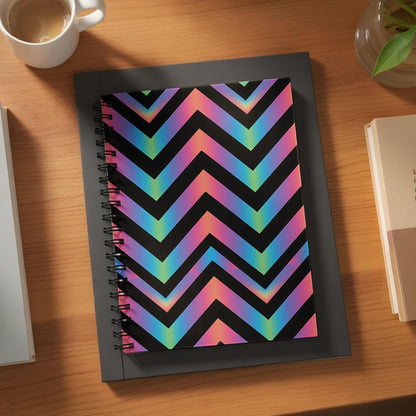 Spiral notebook with a black chevron pattern featuring a rainbow gradient.