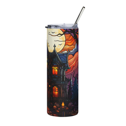 Tumbler with haunted house, moon, and bats Halloween design and a metal straw.