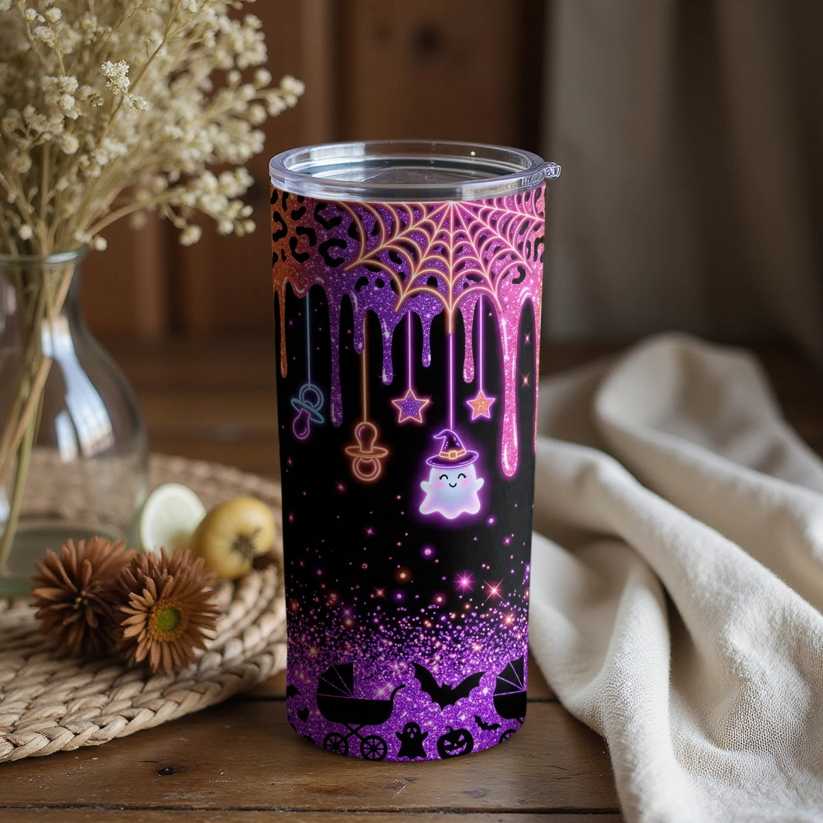 Halloween tumbler with glitter, ghost, baby items, and spooky icons.