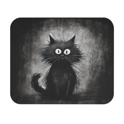 A mousepad features a whimsical black cat illustration with very wide eyes and frizzy fur against a textured grey background.