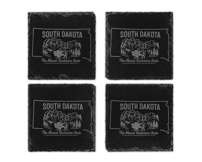 Four South Dakota slate coasters etched with Mount Rushmore and buffalo graphic.