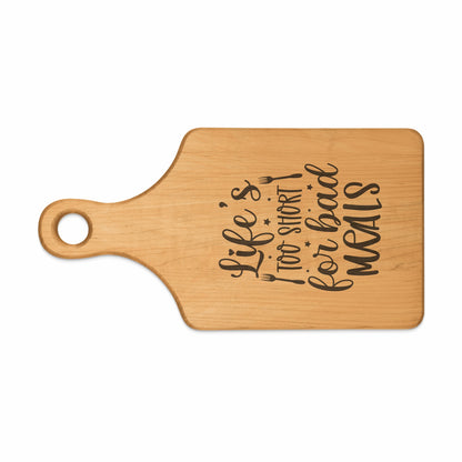 Wooden cutting board with text "Life's too short for bad MEALS".