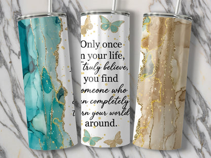 Three tumblers with marble, abstract, and glitter designs, featuring a quote and butterflies.