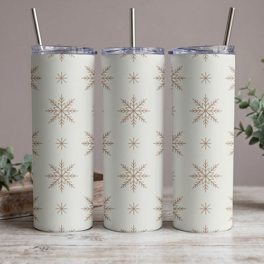 Three tumblers with a repeating brown snowflake pattern on a cream background.