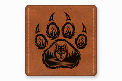 Square brown leather patch with white stitched border and a black laser-engraved wolf paw print design.