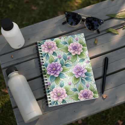 Notebook with purple and pink floral pattern, two water bottles, sunglasses, and a pen.