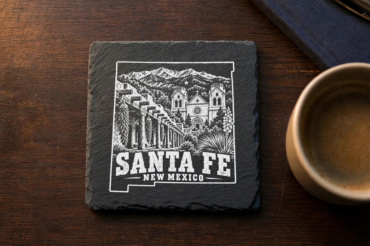 Square slate coaster with a white engraved map outline, Santa Fe landmarks, and text.