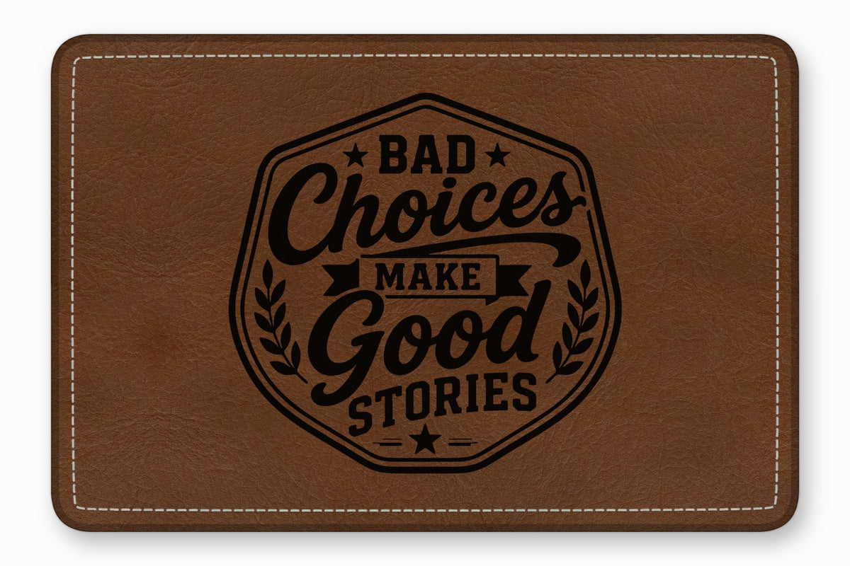 A brown faux leather patch with white stitching and the engraved text Bad Choices Make Good Stories.