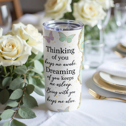 White tumbler with butterflies and the quote "Thinking of you keeps me awake. Dreaming of you keeps me asleep. Being with you keeps me alive."