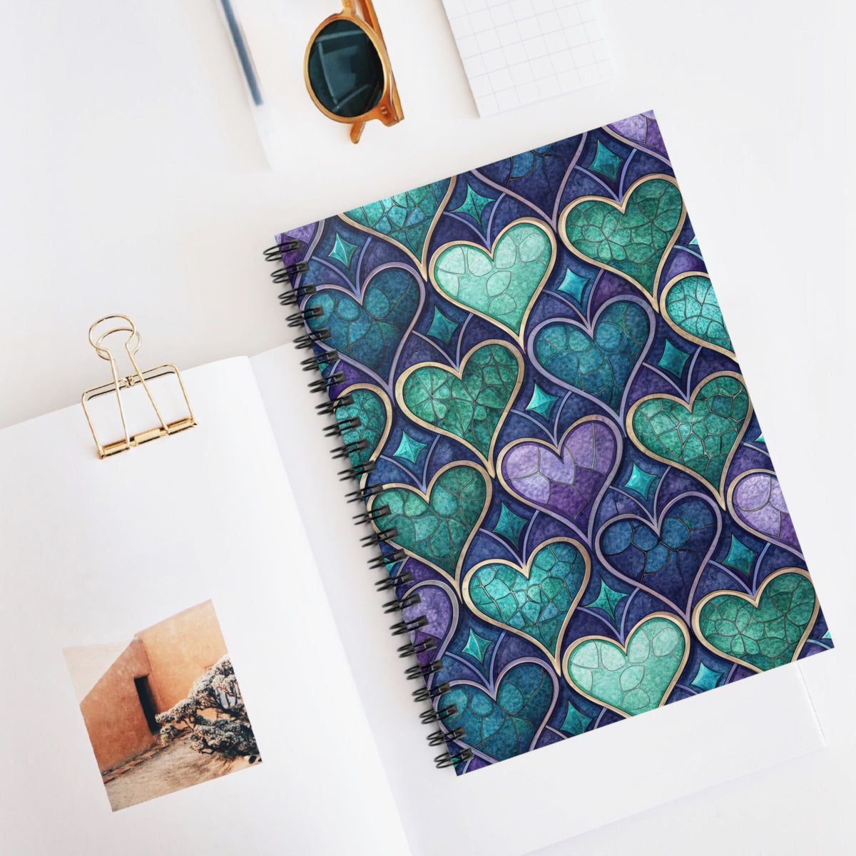 Spiral notebook with a stained-glass heart pattern in purple and teal.