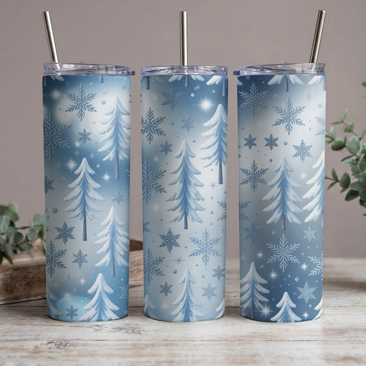 Three tumblers with a winter forest and snowflake pattern, each with a metal straw.