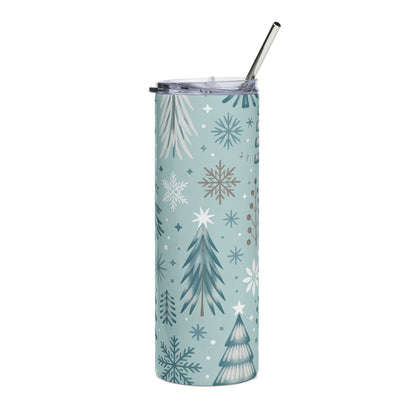 Blue tumbler with white and gray winter forest and snowflake pattern, with straw.