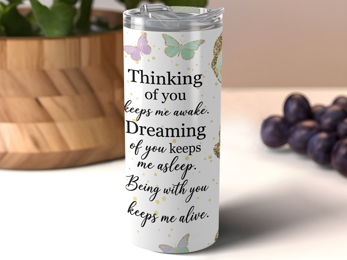 White tumbler with butterflies and text "Thinking of you keeps me awake. Dreaming of you keeps me asleep. Being with you keeps me alive."