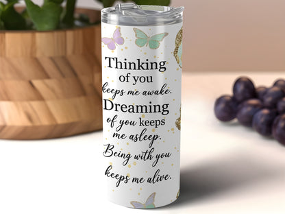 White tumbler with butterflies and text "Thinking of you keeps me awake. Dreaming of you keeps me asleep. Being with you keeps me alive."