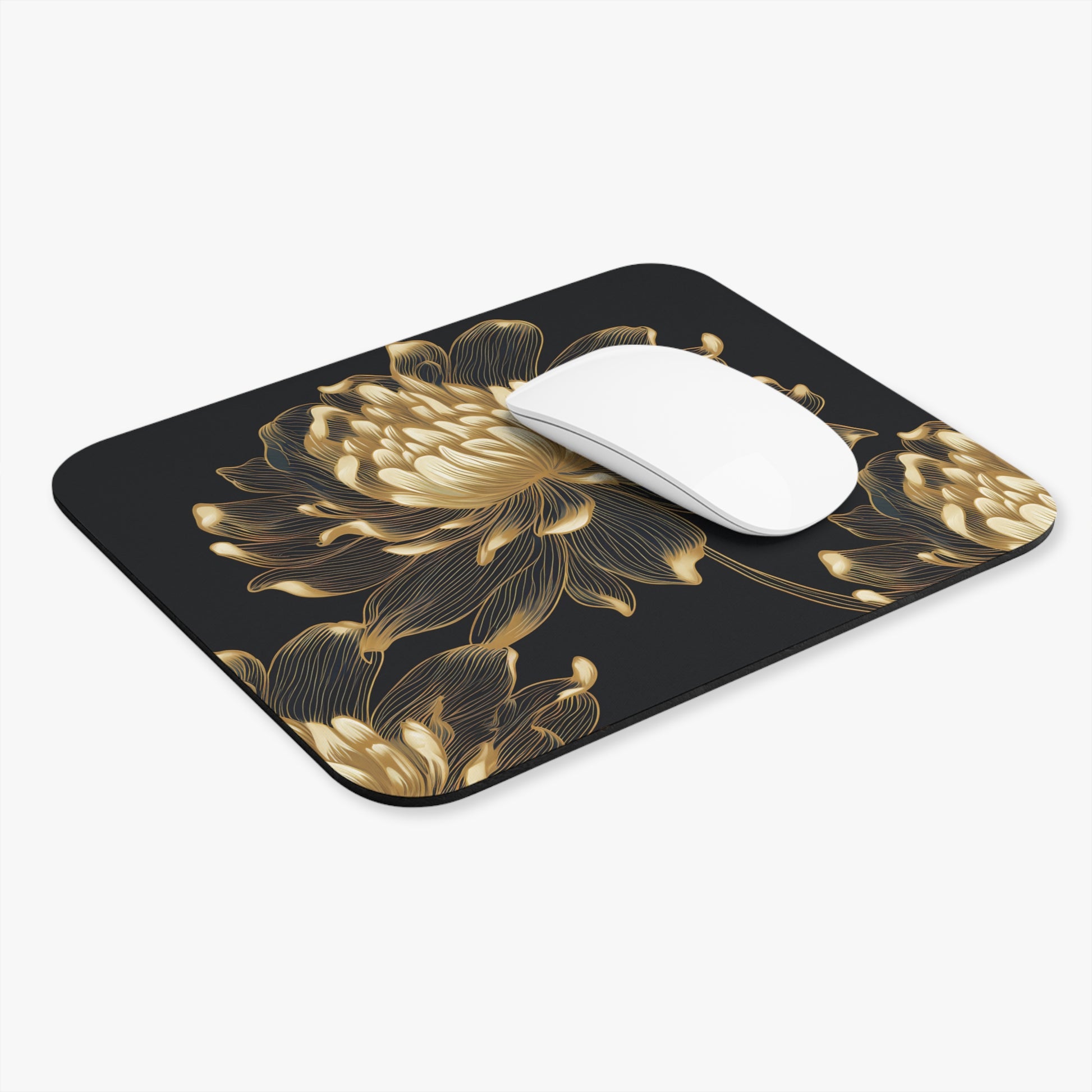 Black mousepad with gold outline floral design and a white computer mouse.
