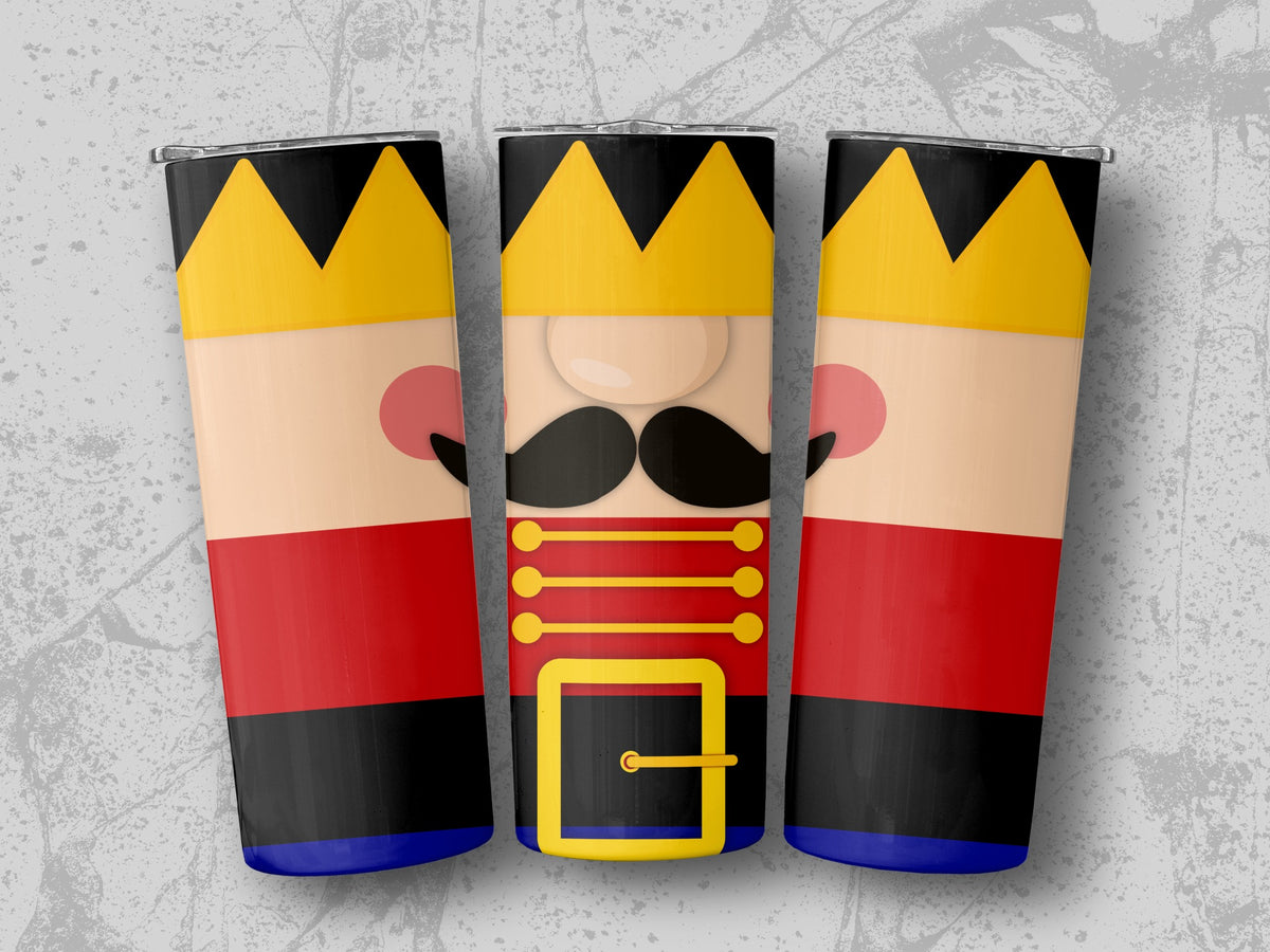 Three nutcracker tumblers with gold crowns and red, black, and blue uniforms.