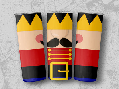 Three nutcracker tumblers with gold crowns and red, black, and blue uniforms.