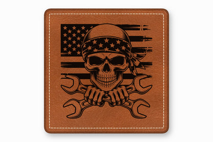 A square brown leather patch with white stitched borders features a skull wearing a star-patterned bandana over an American flag, with crossed wrenches below.