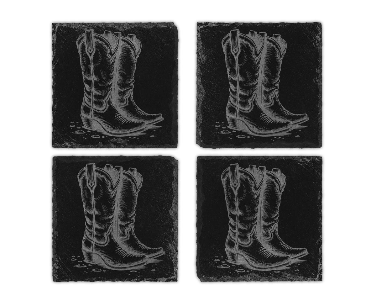 Four slate coasters with etched designs of cowboy boots on black backgrounds.