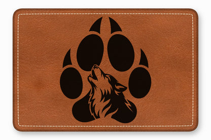 Brown leather patch featuring a black paw print graphic with a howling wolf silhouette.
