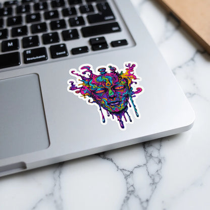 Psychedelic melting face sticker on a laptop keyboard.