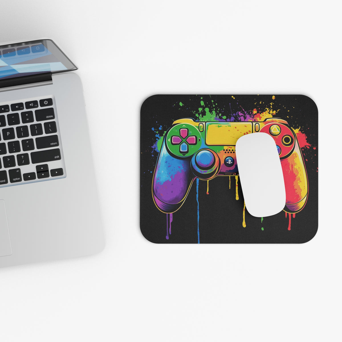 Colorful, dripping controller art on a black mousepad with a white mouse.