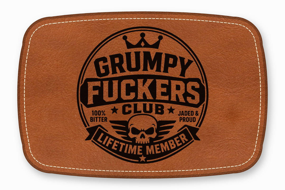 Brown leather patch with rounded corners, white stitching, and a black skull and text graphic.
