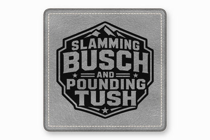 Square grey faux leather patch with white stitched border and black emblem featuring mountain graphic and text Slamming Busch and Pounding Tush.