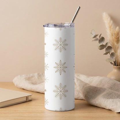 White tumbler with gold snowflake pattern and silver straw.
