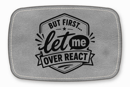 Gray faux leather patch with white stitched border and the black text But First Let Me Overreact.