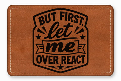 Brown leather patch featuring rounded corners, white stitched borders, and black text reading But first let me overreact.