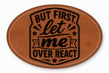 An oval brown leather patch featuring black text that reads But first, let me overreact.