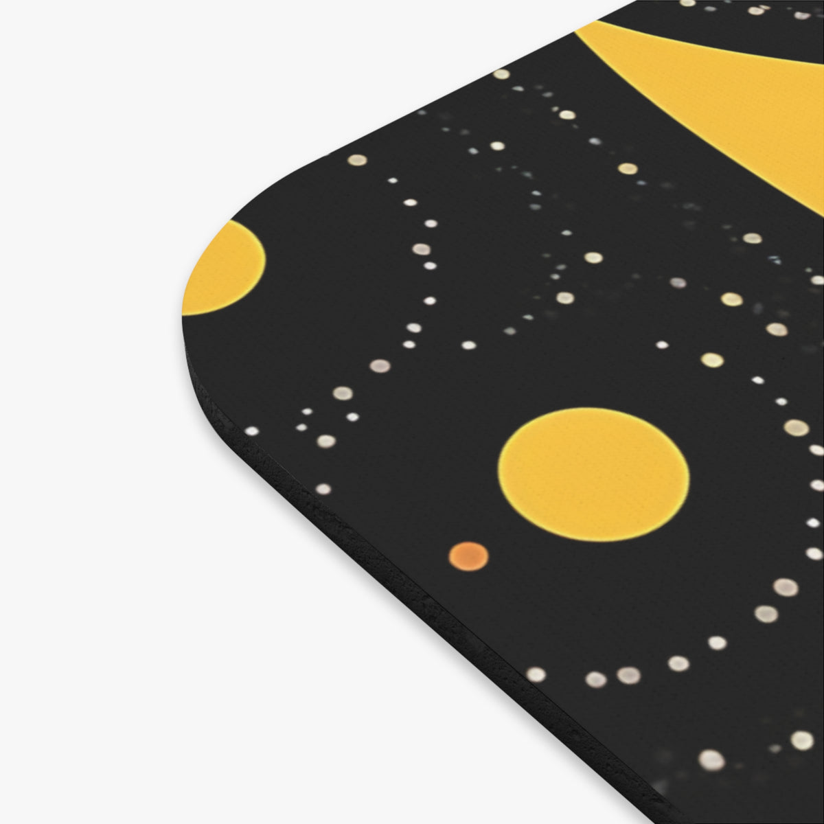 Close-up of a rounded black mousepad featuring a celestial design with yellow planets and white stars.
