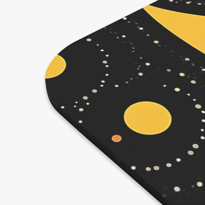 Close-up of a rounded black mousepad featuring a celestial design with yellow planets and white stars.