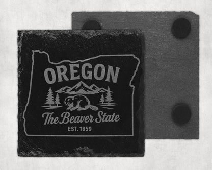 Black slate coaster with Oregon outline, beaver, trees, mountains, and text.