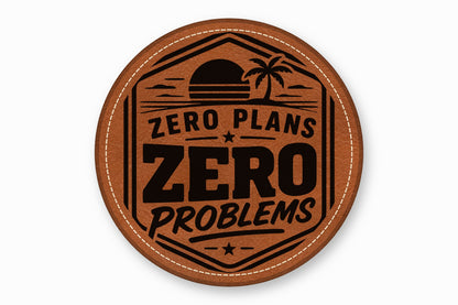 Round brown leather patch with white stitched border, featuring a sunset, palm tree, and text "ZERO PLANS ZERO PROBLEMS".