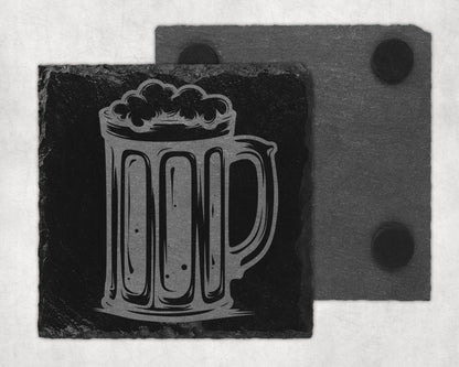Engraved beer mug design on a black slate coaster with a second coaster behind it.