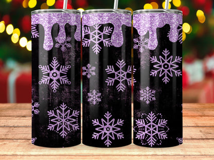 Three black tumblers with purple glitter drips and snowflakes on a wooden surface.
