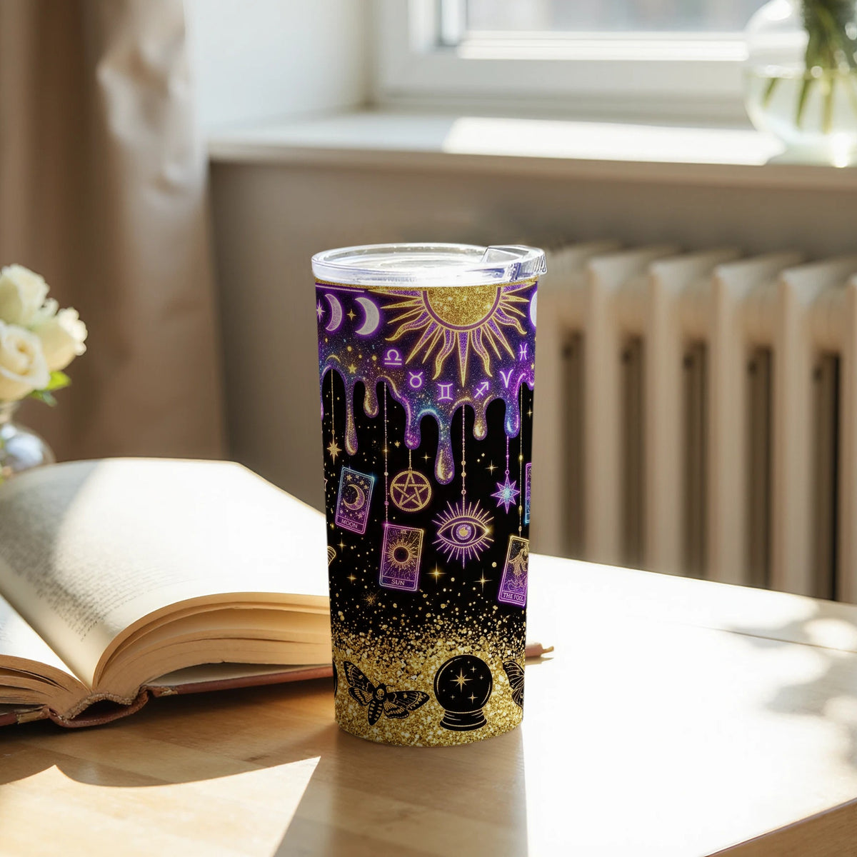 Tumbler with celestial and occult symbols, including sun, moon, eye, and tarot cards.