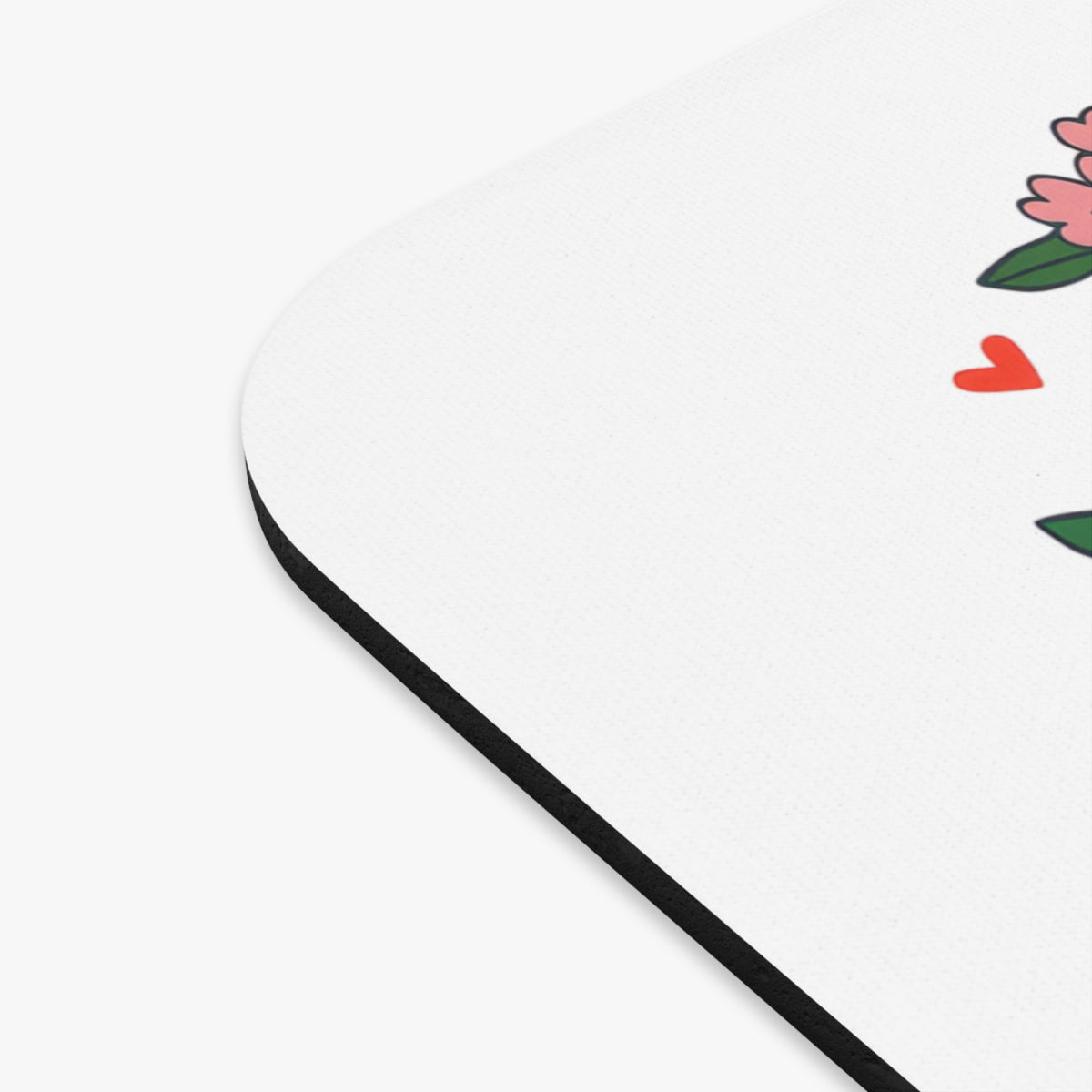 Mousepad with pink flowers, green leaves, and red hearts on a white background.